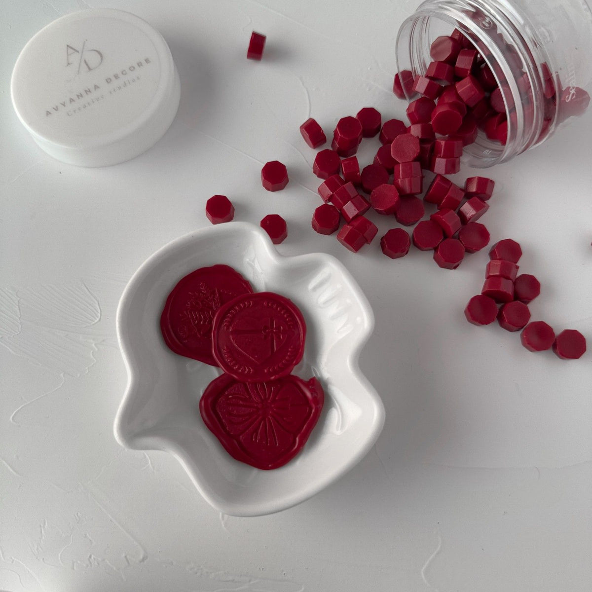 Velvet Dream wax bead hearts in a heart-shaped dish with the open container behind on a clean white backdrop