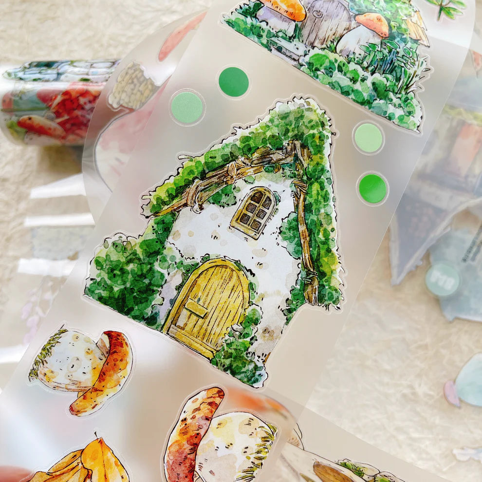 Decorative house-shaped stickers with greenery and a yellow door on a textured surface.