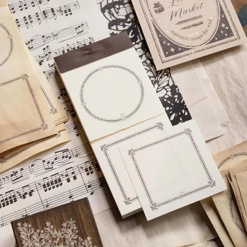 Collection of vintage-style stationery items on a wooden surface