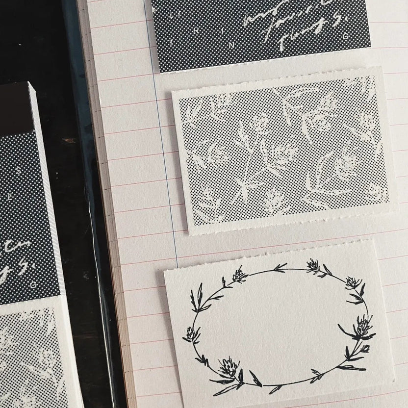 Collection of black and white patterned cards on a lined notebook page.