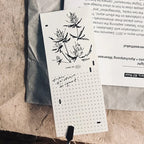 Notebook with floral illustrations and text on a textured surface