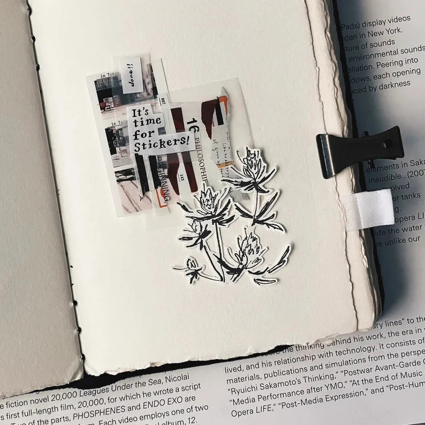 Vintage Hand-Torn Bouquet Memo Pad sheet applied to a book and held with a black clip