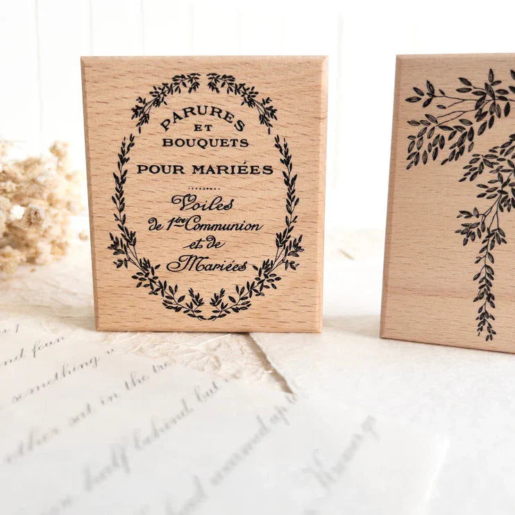 Vintage Rubber Stamp Set wooden stamp with French typography and a floral wreath design, close-up