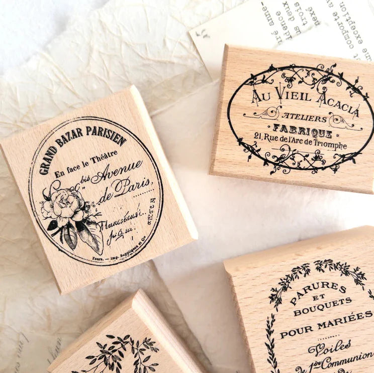 Close-up of Vintage Rubber Stamp Set floral branch, wreath and classic French label stamps