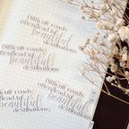 Open book with motivational quote and decorative dried flowers