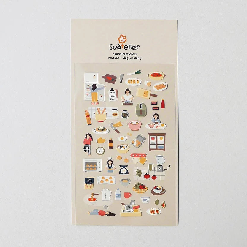 Sheet of decorative stickers with various illustrations on a beige background, featuring the brand 'Sue helier'.
