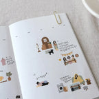 Sticker album with various stickers on a light gray surface