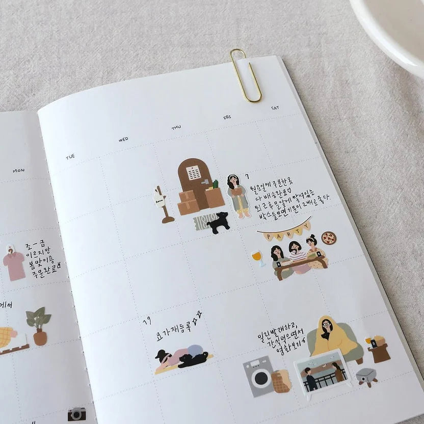 Sticker album with various stickers on a light grey surface, from the Vlog Home Sticker Sheet