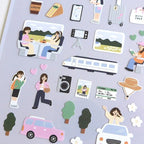 Collection of travel-themed stickers on a gray background