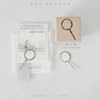 Decorative rubber stamp with magnifying glass design on a white background