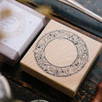 Wooden stamp block with decorative design on a wooden surface