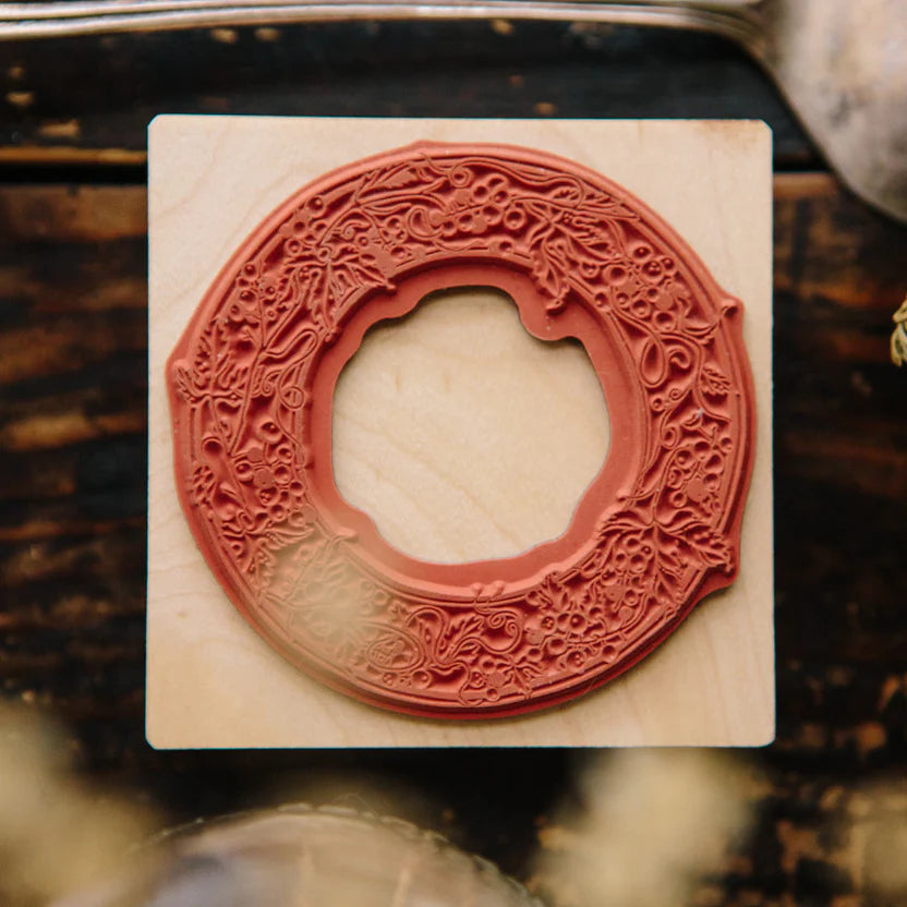 Close-up of the Wild Grape Frame Rubber Stamp circular carved design on its wooden block