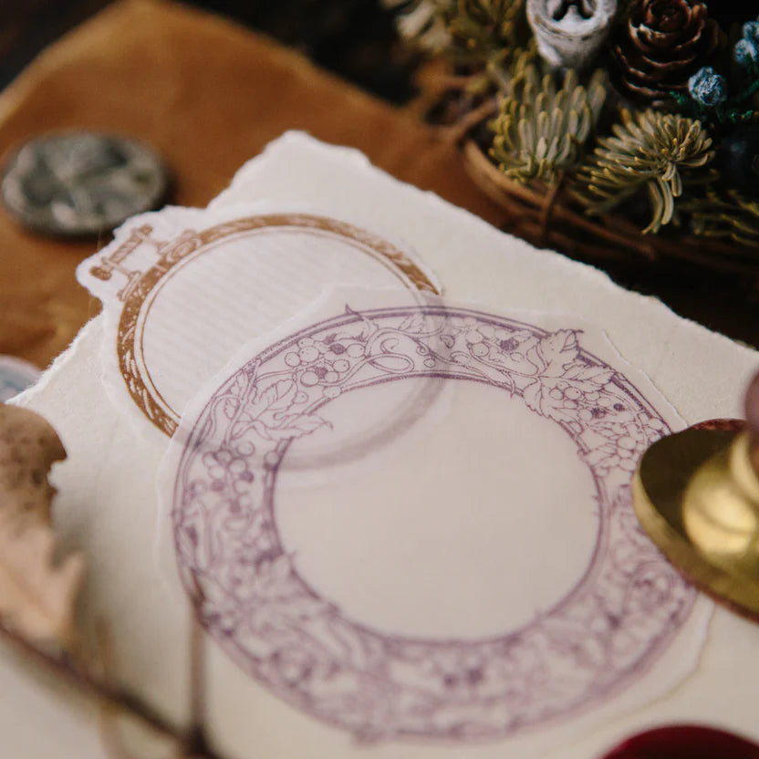 Wild Grape Frame stamp impression in purple and gold on paper on a wooden surface