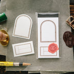 Archival packaging with stamps and tools on a wooden surface