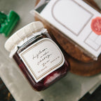 Jar of preserves with a decorative label on a wooden surface