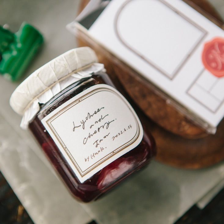Preserve jar labeled with a Window Label Letterpress Memo Pad sheet on a wooden surface