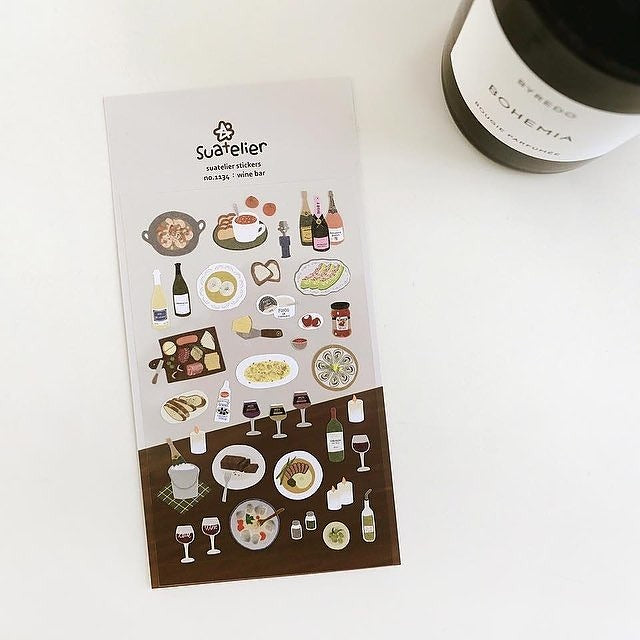 Sheet of food-themed stickers by Suatelier on a white surface with a container labeled 'Bohemia'.