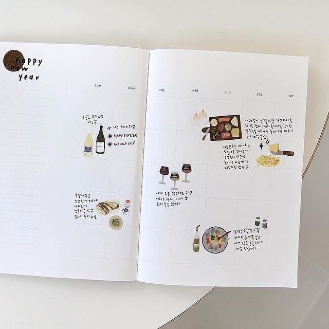 Open book with illustrations and text on a white background