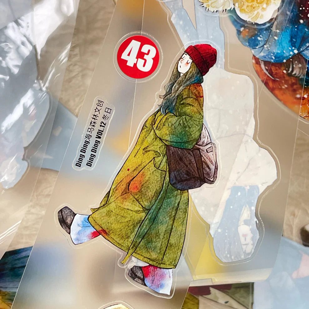 Winter Day PET Tape figure in a yellow coat and red hat with a number 43 label, detail view