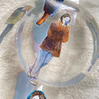Collage of a person in a coat and hat on a textured surface