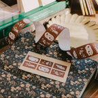 Decorative ribbon with nature-themed design on a floral-patterned surface