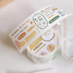 Two rolls of decorative tape with printed designs on a light background