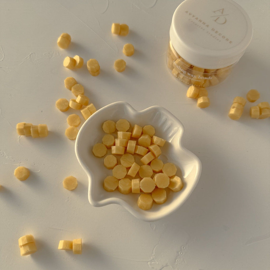 Yellow round candies in a white dish with a container labeled 'A' on a light gray background