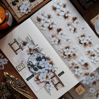 Decorative card with floral elements and stamp set on a wooden surface