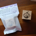 Rubber stamp with packaging on a wooden surface