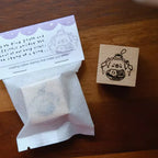 Rubber stamp with packaging on a wooden surface