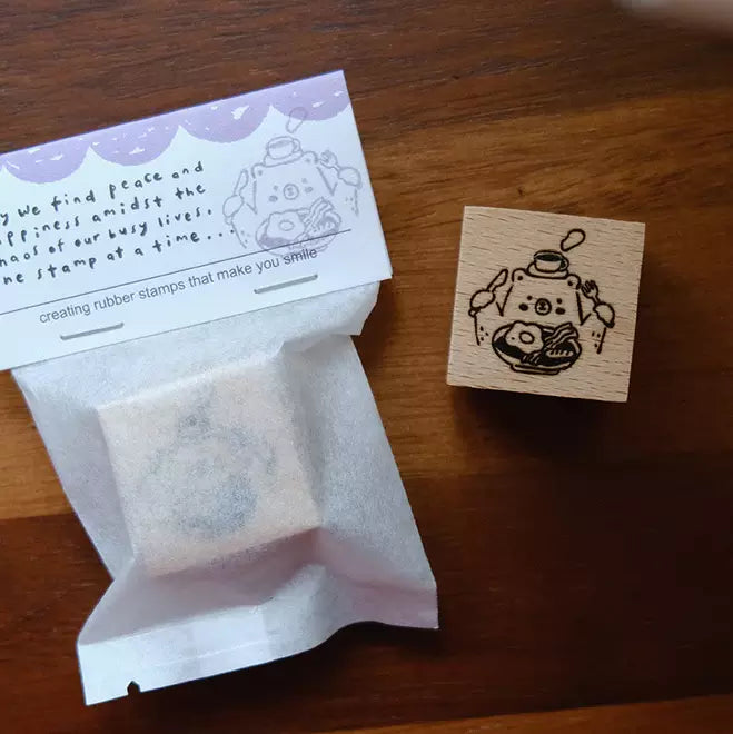Foodie Bears Big Breakfast stamp with its kraft packaging displayed on a wooden surface