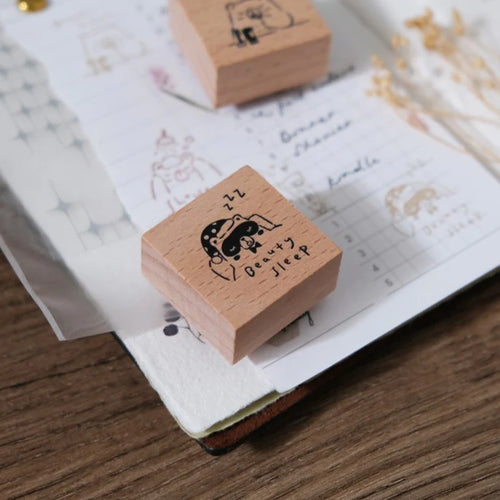 Wooden stamp with cartoon design on a notebook page