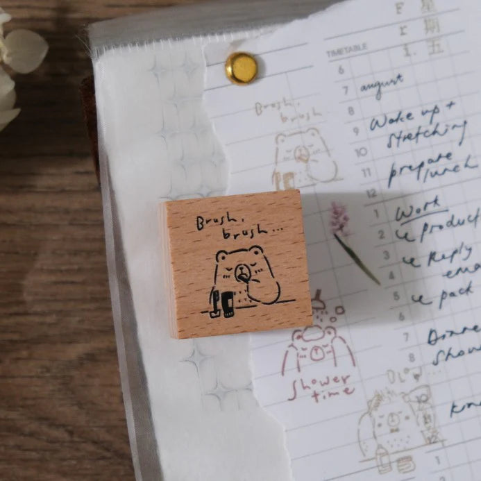 Beary Ordinary Days 04 tooth-brushing bear stamp resting on an open planner page