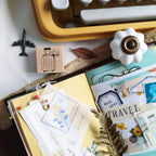 Stationery items including a rubber stamp, stationery set, and decorative elements on a surface.