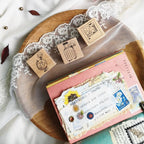 Decorative rubber stamps and stationery items on a lace-draped surface