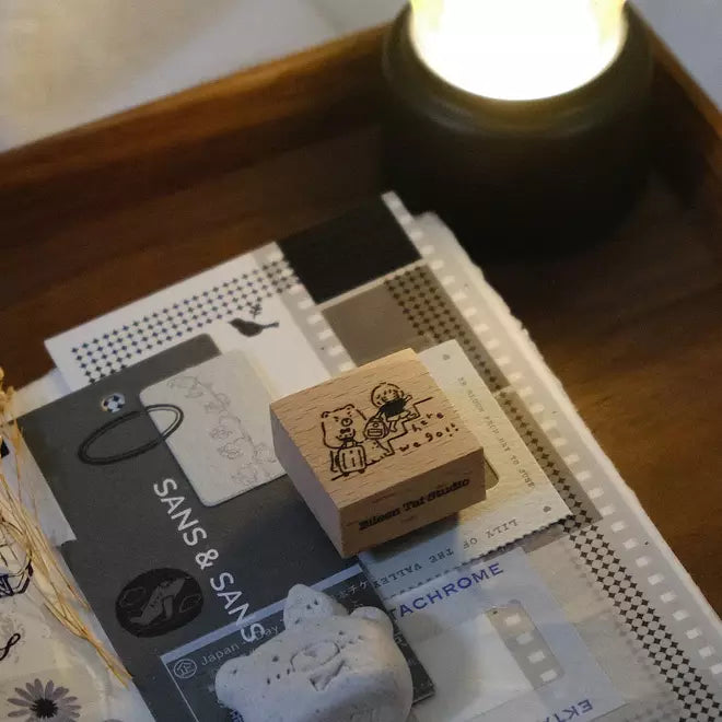 Here We Go stamp from the Travel Together Again set resting on a stack of books with text