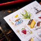 Sheet of decorative stamps with various designs on a wooden surface