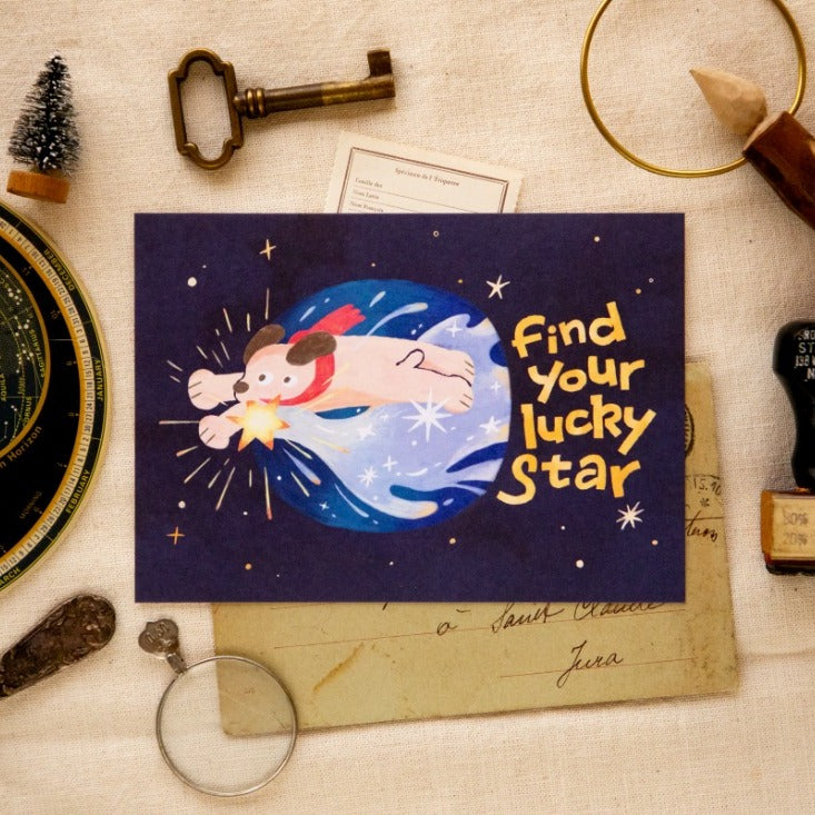 I Found a Star Post Card by OURS Studio — dog 'find your lucky star' postcard on a vintage desk, for journaling