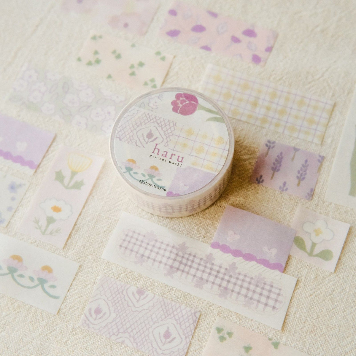 Washi tape with floral and checkered patterns on a textured surface