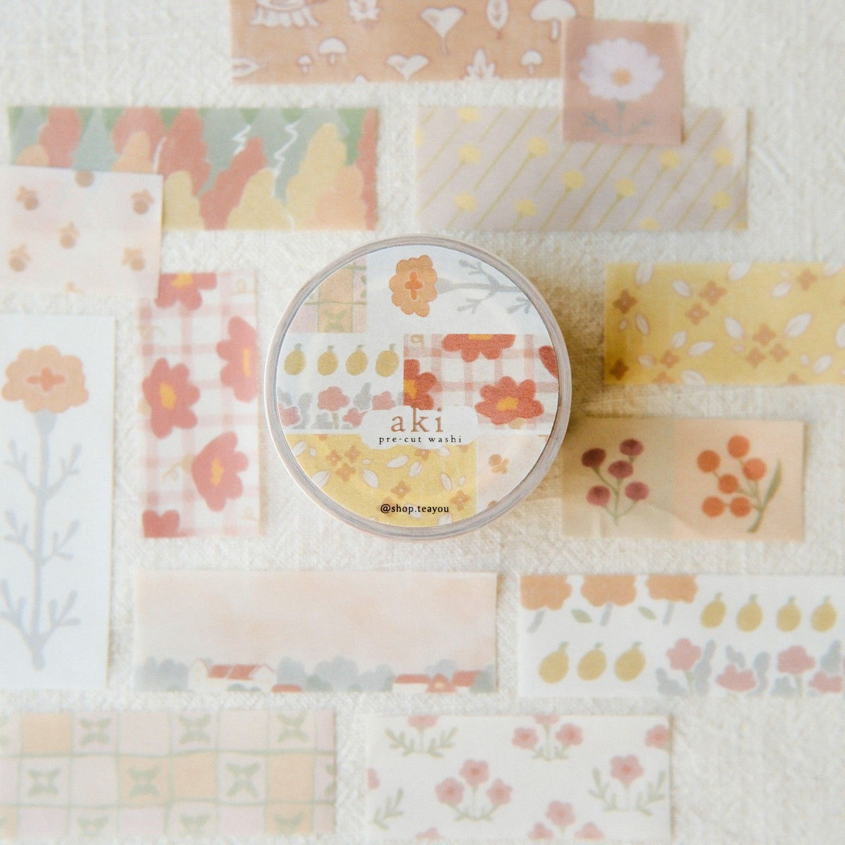 Set of floral-patterned paper sheets with a round container labeled 'aki' on a white background