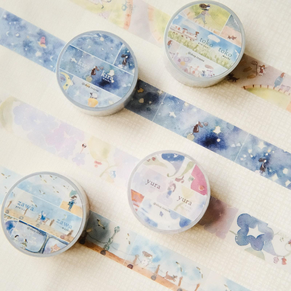 Set of washi tape rolls with cute illustrations on a light background