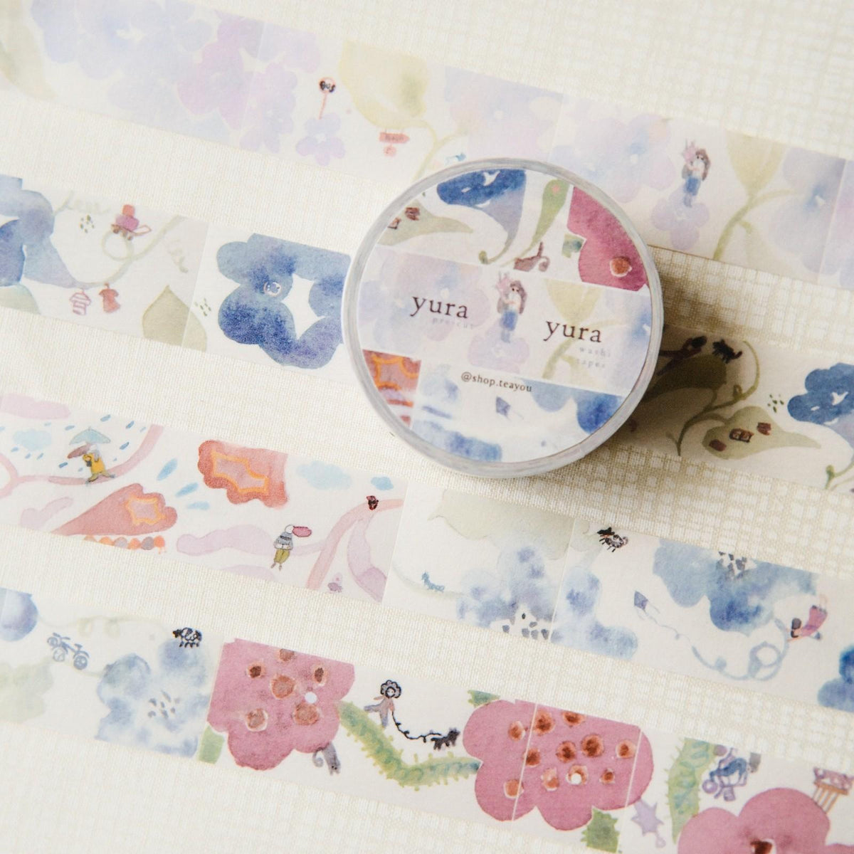 Decorative washi tape with cartoon designs on a matching paper background