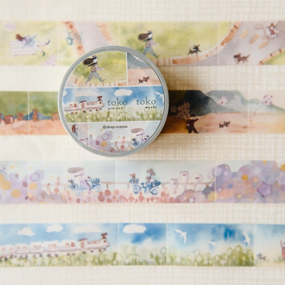 Washi tape set with scenic designs and a tin labeled 'toko toko'.