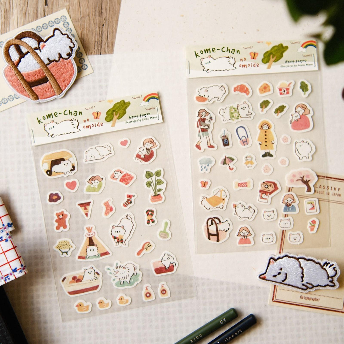 Sticker sheets with cute illustrations on a textured surface