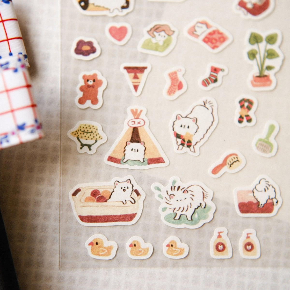 Collection of cute illustrated stickers on a textured surface