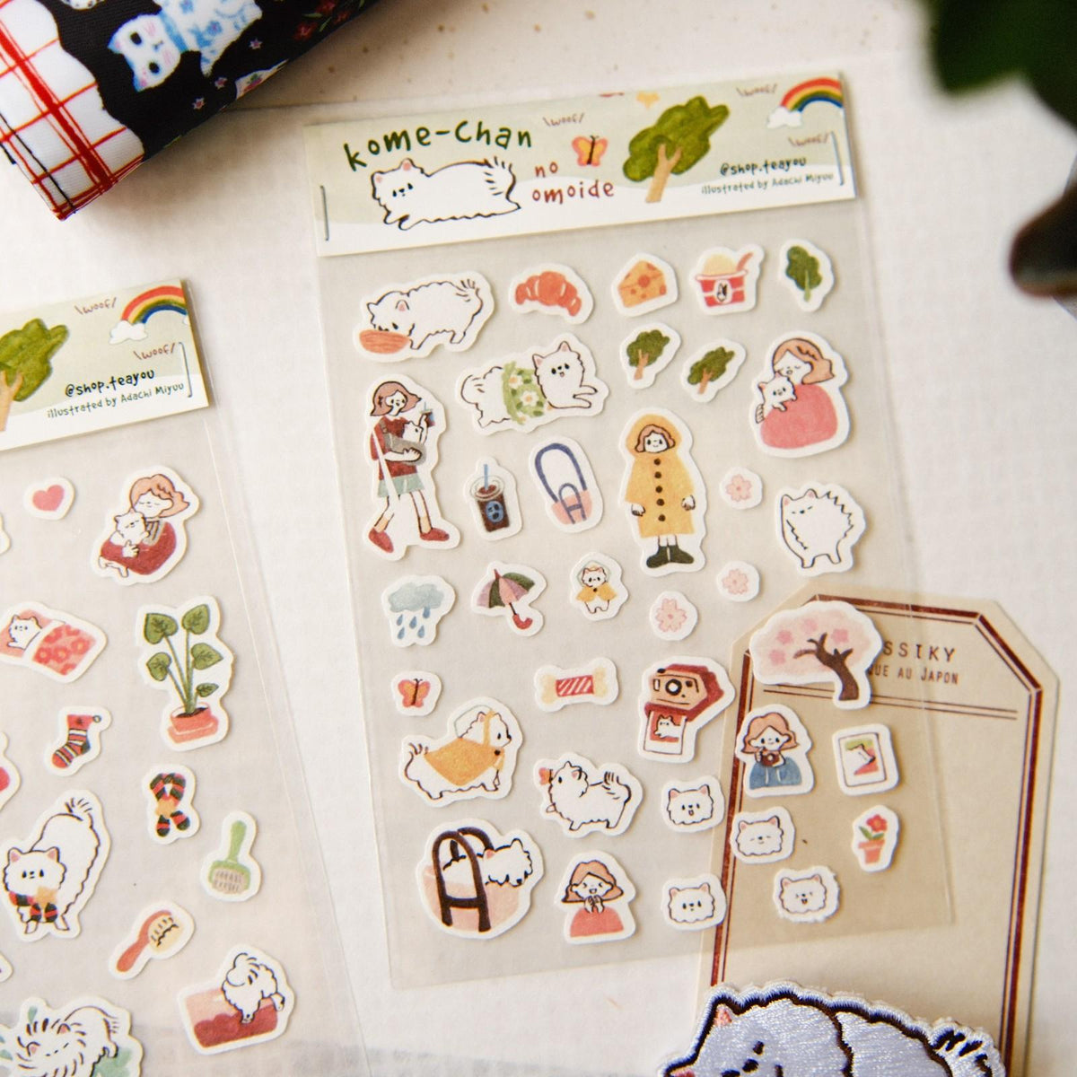 Sheet of cute character stickers with a 'kome-chan' label on a light surface.