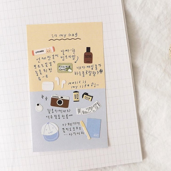 Notebook with decorative stickers on a textured surface, from the In My Bag Sticker Sheet