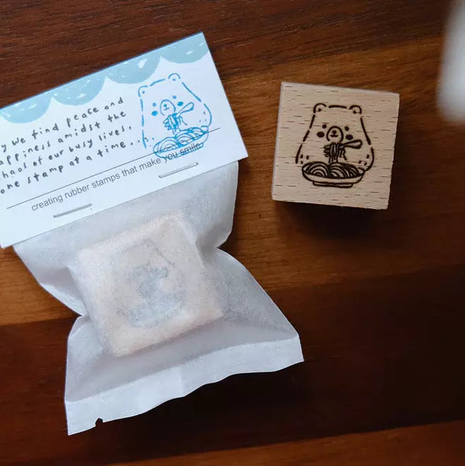 Foodie Bears Spaghetti bear stamp with packaging and a stamped card on a wooden surface