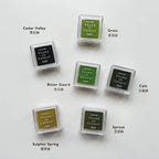 Set of green ink pads with labels on a white background