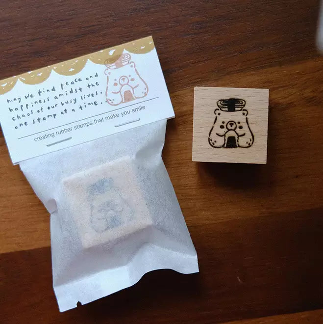 Foodie Bears Sushi and Onigiri bear stamp with a labeled package on a wooden surface
